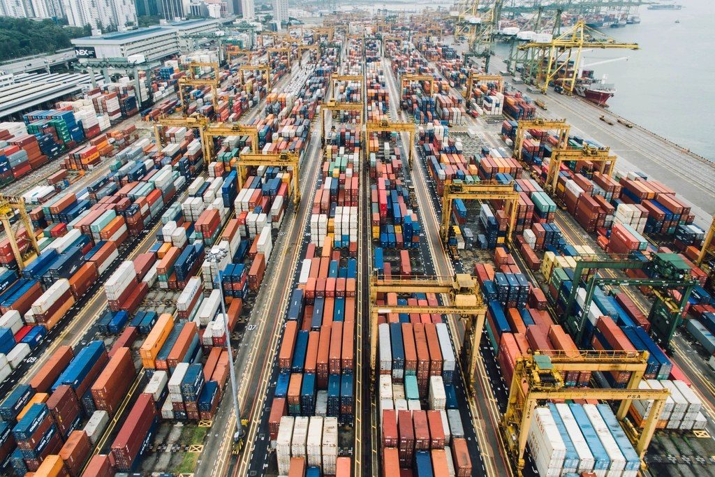 Aerial view of shipping containers stacked at a busy port